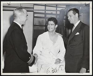 V-E Day Anniversary at Chelsea Naval Hospital found Rear Adm. Morton L. Deyo, USN, Commandant, First Naval District, greeting Pfc. James E. Metsinger, USMC, nephew of Gov. Tobin, at the start of exercises.