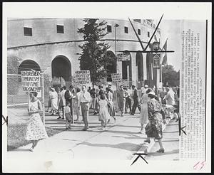 Pickets Denounce Czech Clergyman--While Dr. Joseph Hromodka, a leading churchman of Communist Czechoslovakia, was addressing the World Council of Churches here Sunday these pickets who described themselves as Czech exiles marched on sidewalk outside. Building in background is Dyche Stadium adjoining McGaw Hall where the church assembly is meeting. Dr. Hromodka declared "God is present even where no man would dare to expect Him."