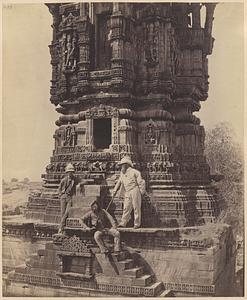 View of base of the Kirti Stambha, Chittorgarh, India, with three unidentified men