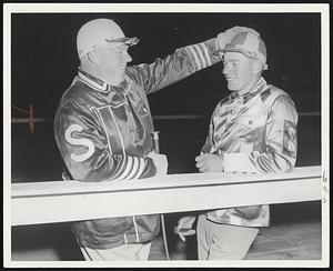 The boy's growing up. Franklin Safford, left, one of New England's all-time harness greats, back at Rockingham for the first time since last Fall, pays his respects to youthful Paul Battis, leading driver at Foxboro this summer. Safford and Battis are both New Hampshire natives.