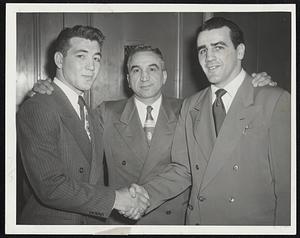 New Boston University Football Captain is Guard Lou Salvati of Cranston, R. I. (left), being congratulated by his predecessor, Art Boyle. Center is Coach Buff Donelli. Announcement was made at the B. U. all sports banquet at Hayden Memorial Auditorium last night.