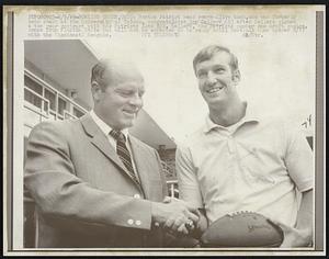 Boston Patriot head coach Clive Rush, who was formerly head coach at the University of Toledo, congratulates Ron Sellers (R) after Sellers signed a two year contract with the Patriots late 8/8. Sellers, the Patriots number one draft choice. comes from Florida State but will not be expected to be ready until BostonIs home opener 8/17 with he Cincinnati Bengals.