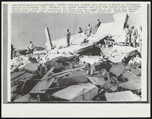 Rescuers clamber over rubble in search of earthquake victims or survivors 7/23. following the killer tremors late 7/22 that rolled northwest Turkey along fault line stretching 300 miles from the Aegean Sea to the Black Sea. Despite wide-spread damage, loss of life has been relatively low.