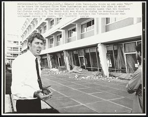 Senator John Tunney, Jr. holds up and asks "Why?" as he tours the damaged Olive View Sanitarium and examines the ruins in which one patient of the sanitarium was killed by the massive quake that hit Southern California early 2/9. The death toll was steadily rising as rescuers probed through the rubble of two hospitals in the Northern San Fernando Valley that collapsed during the quake.