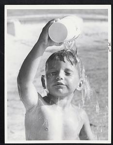 Whoosh! That's better-Stephen Carroll, 4, of Hamilton, Canada, visiting relatives in Chelsea, cooled off in wading pool on Boston Common.