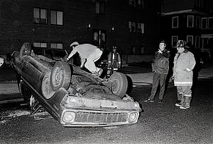 Chelsea Fire E2 Lt. Adolph Spinazolla as Jerry's Towing driver Paul Koolloian prepares to upright the rolled over vehicle