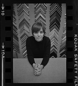 Portrait of woman in front of frame samples