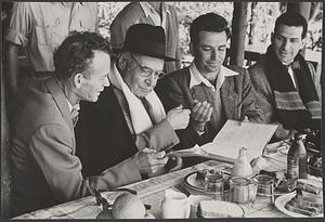 Serge Koussevitzky seated with three unidentified men