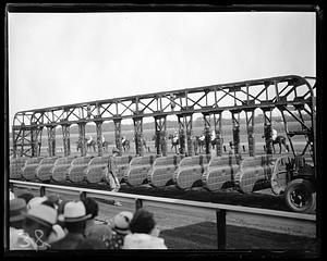 Starting gates at a racetrack being set up
