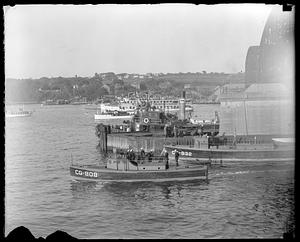 Ships in water including rum chasers CG-808 and CG-832 and ferry Nelseco II in background
