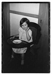A girl in a high chair