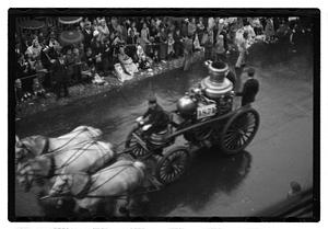 A horse drawn fire engine with a sign, "1871"