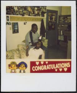 Two friends smiling on a couch