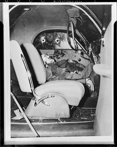 Shooting victim in bullet riddled auto