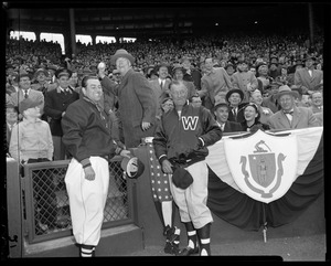 Gov. Herter throws out the first ball as Lou Boudreau, Red Sox manager, and Bucky Harris, Senators Manager, look on.