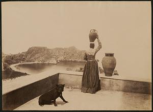 Woman with vessel on head, overlooking Capo Sant'Andrea, Taormina, Sicily