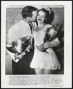 A Kiss for a Pretty Champion Skater--Dick Button, Harvard sophomore, gives Yvonne Sherman of New York a congratulatory kiss as they hold their trophies last night after successfully defending their national figure figure skating championships in the 1950 competition here. The title is the fifth straight for Button in the senior men’s class. Miss Sherman is senior women’s champion.