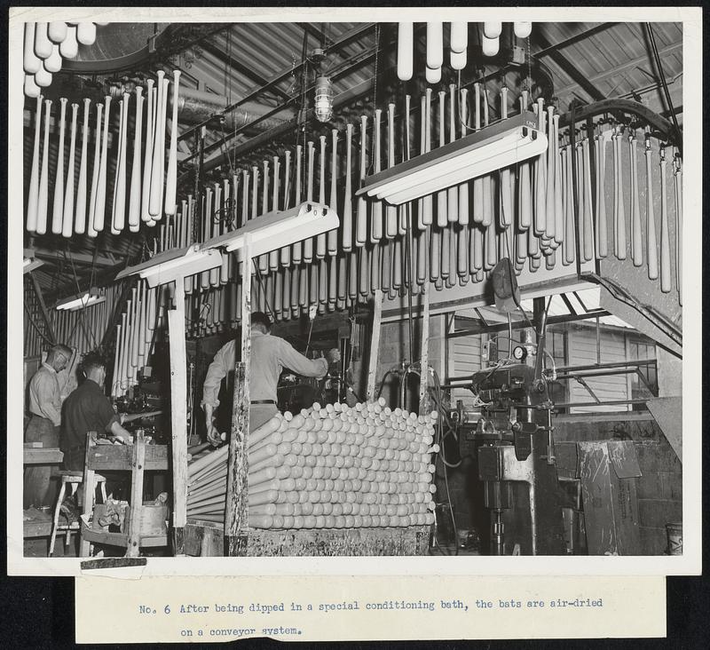 After being dipped in a special conditioning bath, the bats are air-dried on a conveyor system.