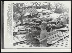 Refugee Wonders in Camille Wake--A small boy walks through the wreckage of homes in Mississippi City, Miss. after the fury of 180 mile per hour winds from hurricane Camille struck the gulf coast Sunday night. The storm has left thousands homeless and the death toll has reach 128.