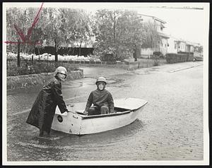 Taking Advantage of high water on Broadside avenue, Revere, for a boat ride were John Papa, 12, and Jimmy Belliveau, 11.