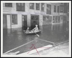 Backlash Of Hurricane strikes Greater Boston. Dane Hall and Alice Robinson go colling on Twharf residents via rowboat.