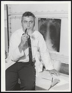 Dr. Raphael Adar beside the X-ray of a patient at Beth Israel Hospital where he has returned after treating wounded Arabs during war in the Middle East.