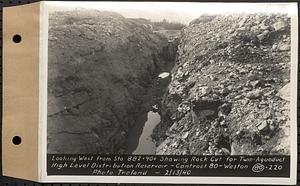 Contract No. 80, High Level Distribution Reservoir, Weston, looking west from Sta. 882+40+/- showing rock cut for twin aqueduct, high level distribution reservoir, Weston, Mass., Feb. 13, 1940