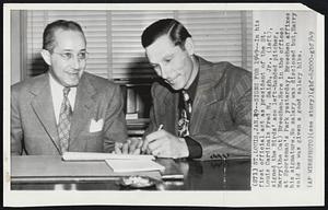 Signs for 1949-- In his first official act as president of the St. Louis Cardinals Fred M. Saigh, Jr., (left), signed the Birds' ace left-handed pitcher, Harry (the Cat) Breechen. Here in the offices at Sportsman's Park yesterday, Breechen affixes his signature. No salary was disclosed but, Harry said he was given a good salary hike.