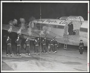 Six-Gun Salute for Late Ed Sanders as body is flown to Los Angeles for burial tomorrow. Officers in plane with flag-draped coffin are (left to right) Comdr. Arthur H. Damon and lt. John Cremmen. Outside plane stands CPO John Maloof. Heading firing squad at right is Petty Officer Philip Freeman. Firing squad (left to right) - Herbert H. Jameson, Michael Pichnarczyk, George Ballard, Joseph Steinbrecher, Skip Godbey and Arthur Golly.