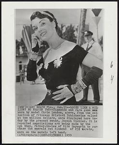 Looks Like a Million? No Nearer Two--Diamonds and rare gems worn by model Chris London, above, from the collection of Princess Eristavi Tchitcherine valued at two million dollars, were displayed here today by the present owner, Joseph Richter. It is reported negotiations are being made by the Aga Khan, Father-in-Law of Rita Hayworth to purchase the emerald cut diamond of 23 1/2 carats, worn on the models left hand.