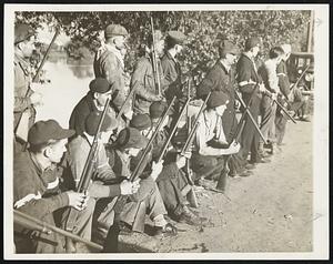 Deputized Monroe, Mich., civilians armed with rifles, shot guns and side arms, are shown on guard at a road leading to the Newton Steel Mill, prepared to resist with gunfire any retaliation by CIO forces for the shattering of its picket line.