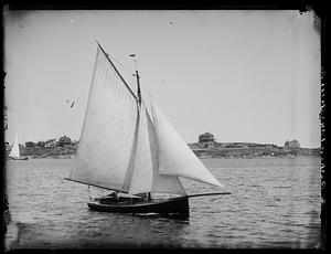 Boat sailing, view of coastline in background