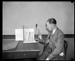A man holding a saw next to a variety of blades