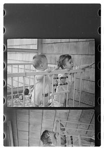 Two children in a playpen