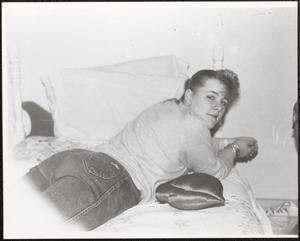 Young woman lounging on a bed