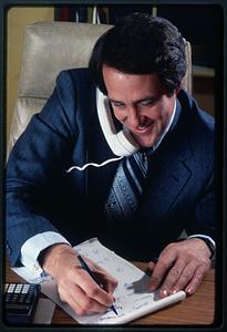 Businessman talks on phone, Waltham