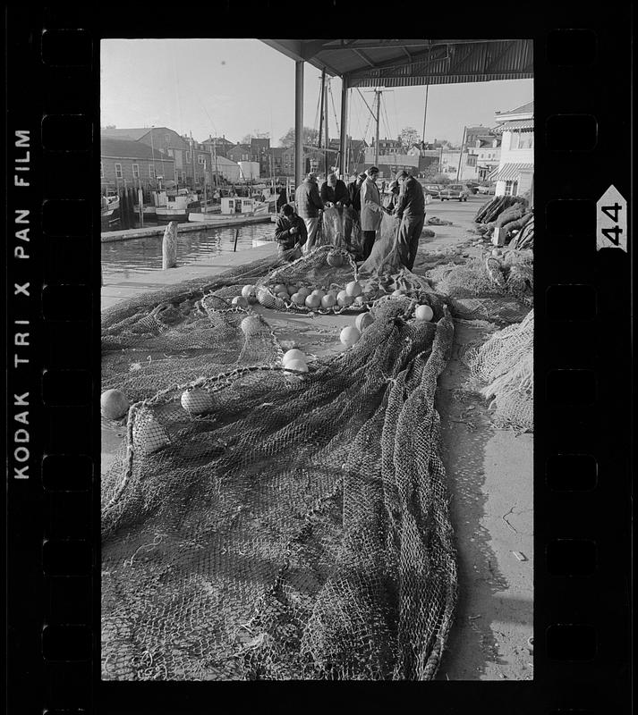 Fish nets laid out to dry on pier, Gloucester, MA