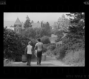 Boys walk down path near the Island Inn Hotel, Monhegan Island, Maine