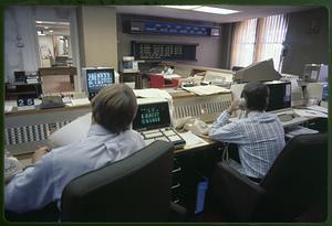 Stockbrokers watch market data on computer screens, Boston