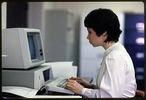 Secretary at work on I.B.M. personal computer, Boston