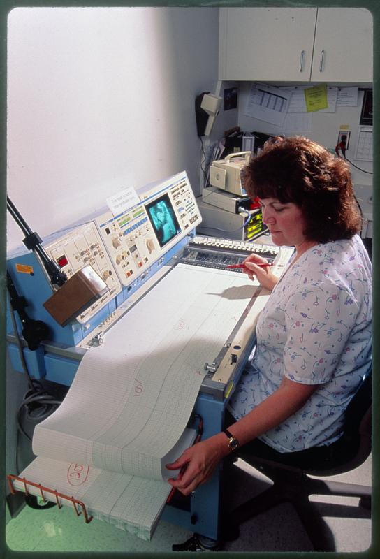 Nurse runs printout of patient heartbeat, Boston