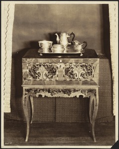 Silver coffee/tea service with tea pot, creamer, bowls, tray on elegant wood/inlay desk