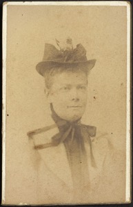 Woman in hat and neck tie bow