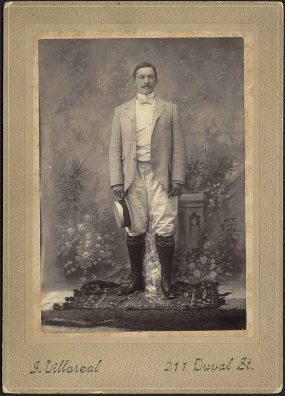 Studio portrait of John Gardner Coolidge holding straw hat