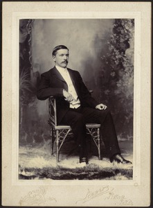 Studio portrait of John Gardner Coolidge sitting in chair