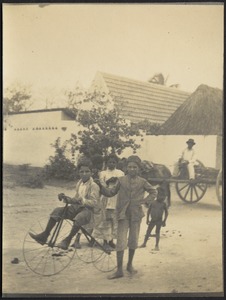 Children playing in street (with tricycle)