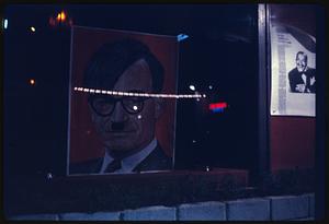 Night view of poster with Barry Goldwater portrayed as Adolf Hitler, likely San Francisco