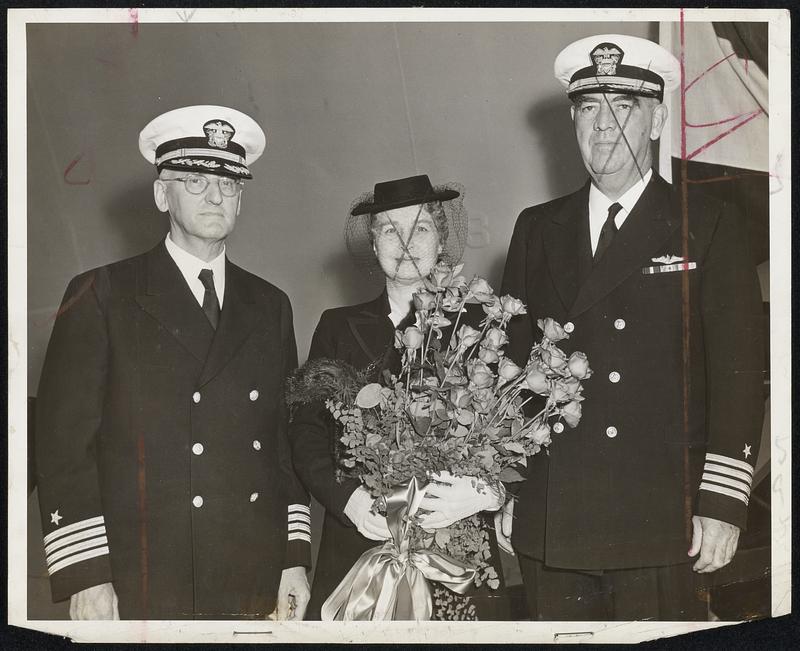 Warship for British Launched Here- The destroyer escort H.M.S. Gardiner went down the ways yesterday at the Boston Navy Yard, sponsored by Mrs. Clarence A. Abele (center) of 180 Commonwealth avenue, Boston. Her husband, Capt. Abele (left) is in charge of the Fargo naval receiving station, South Boston. Also shown is Capt. Ronan C. Grady, captain of the Navy Yard. Mrs. Abele has two sons in naval service.