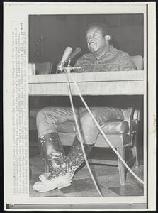 With Mud-Caked Boots The Rev. Ralph Abernathy, head of the Southern Christian Leadership Conference and leader of the Poor People's Campaign, displayed mud-caked boots as he testified today before a Senate subcommittee holding a hearing on employment, manpower and poverty. Before testifying, Abernathy had been at Resurrection City which is covered with ankle-deep mud after two days of rain.