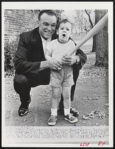 Dick Sisler, former Cincinnati Reds manager, gives his son Ricky some batting tips at his home here 10/19 after it was announced that he had been hired as a coach by the St. Louis Cardinals. Sisler will replace Mickey Vernon in the first base coaching box for the Redbirds.